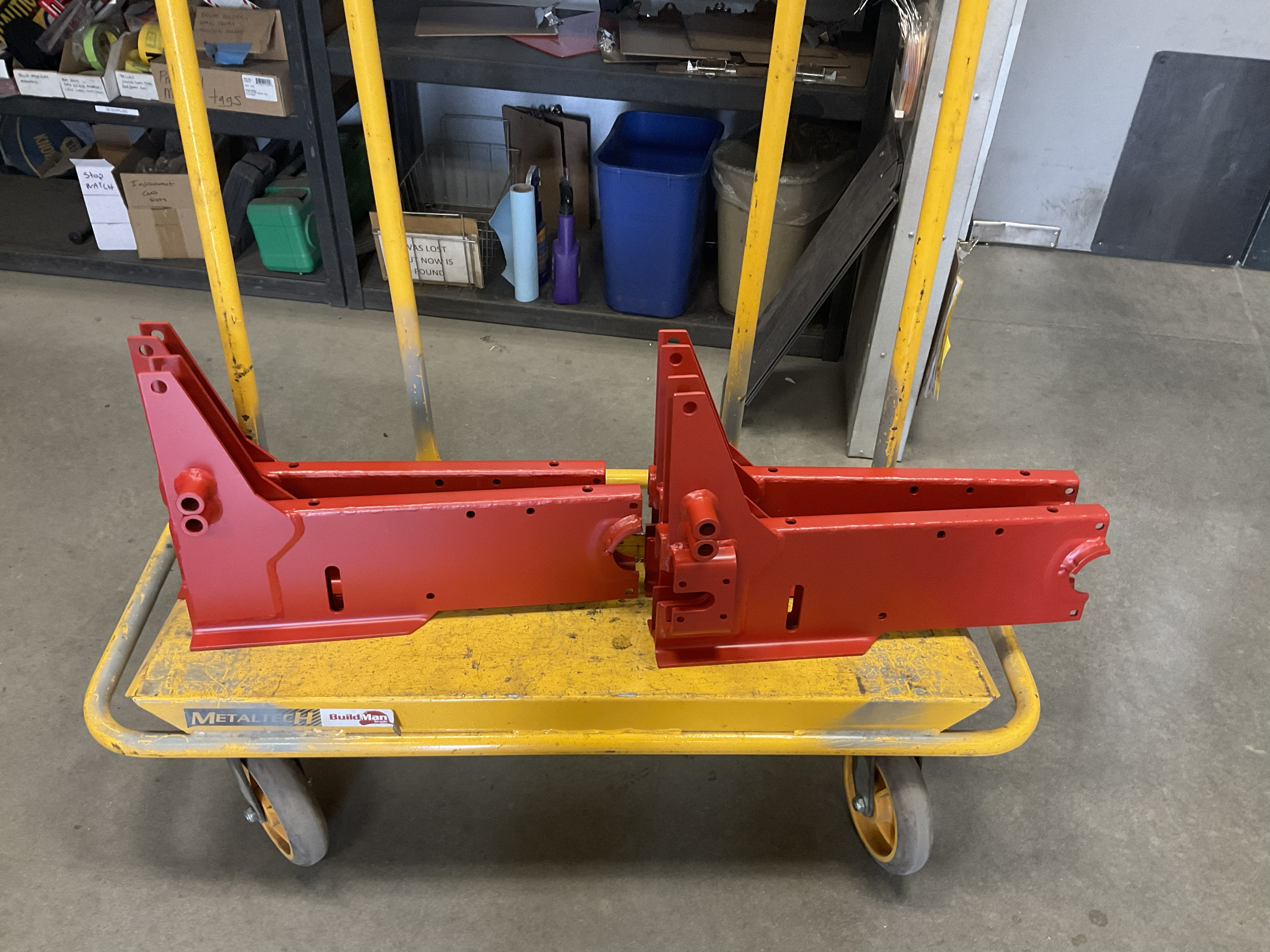 Freshly painted fabricated components inside the Barnes Welding shop