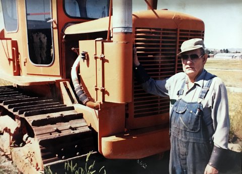 Weldon Barnes standing beside an HD16 tractor