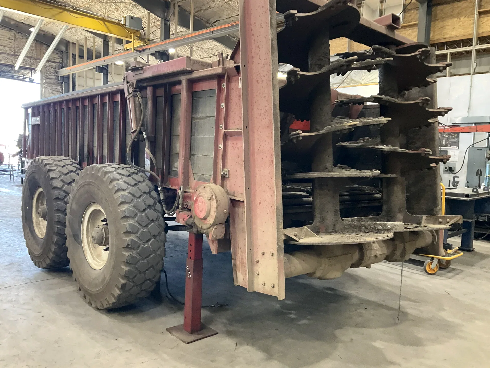 Large agricultural equipment positioned for repair inside the Barnes shop
