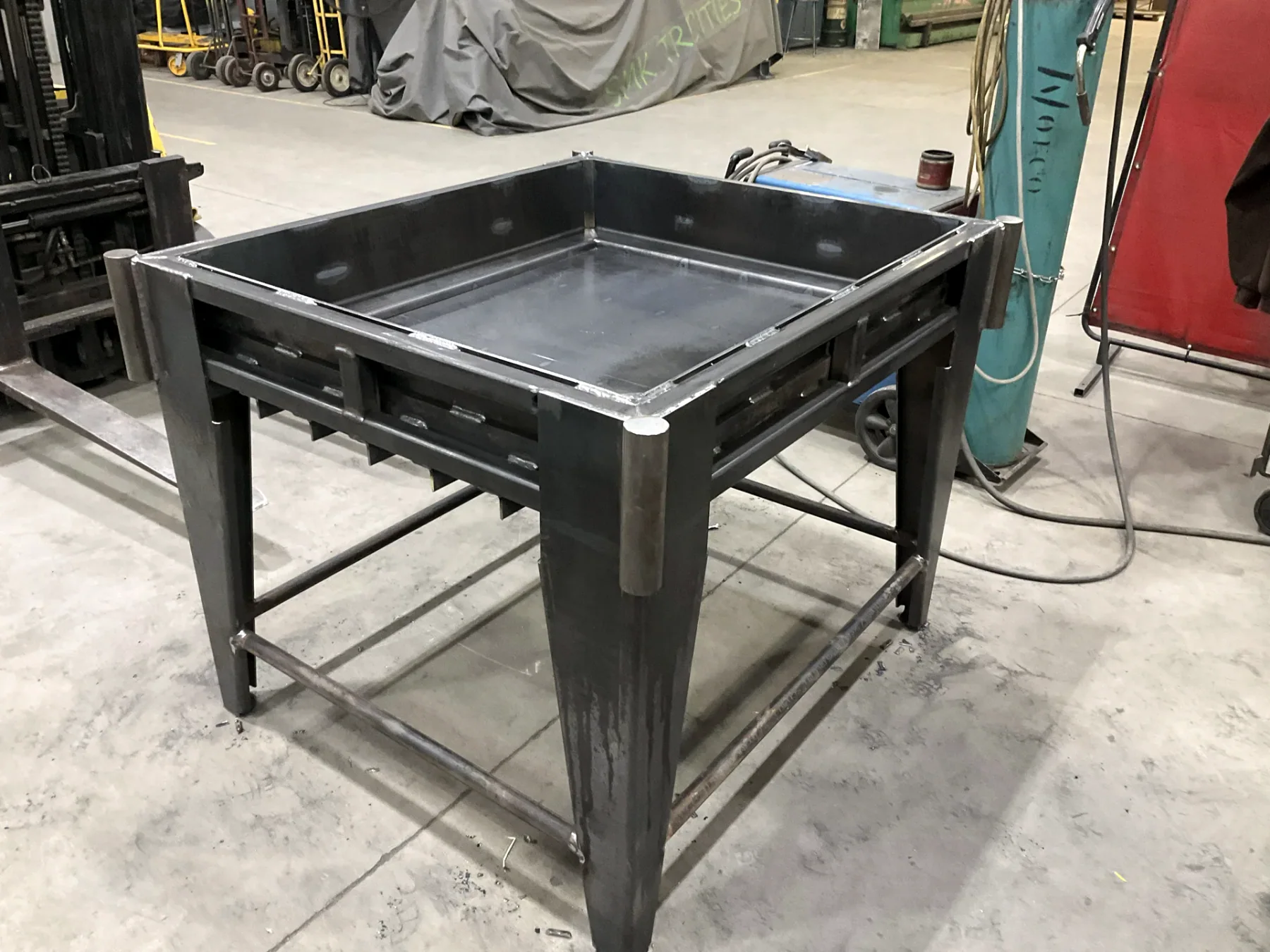 Custom welded steel table and tray assembly in the Barnes shop