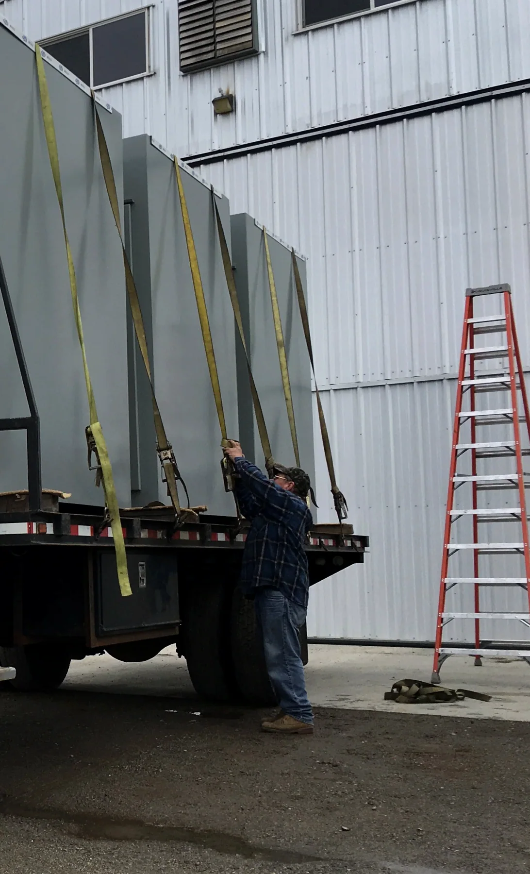 Multiple finished gray electrical enclosures prepared for delivery